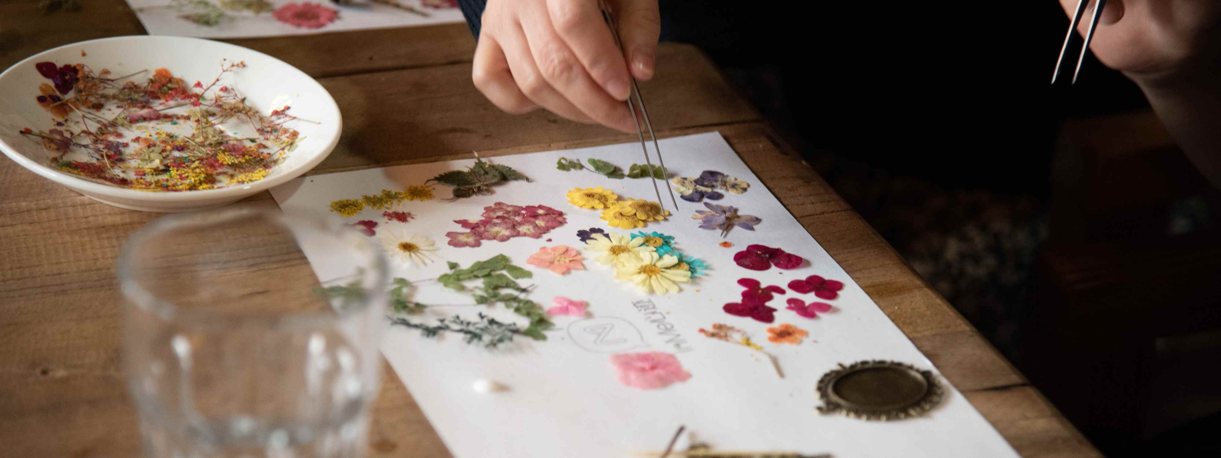 woman making a canva of pressed flowers